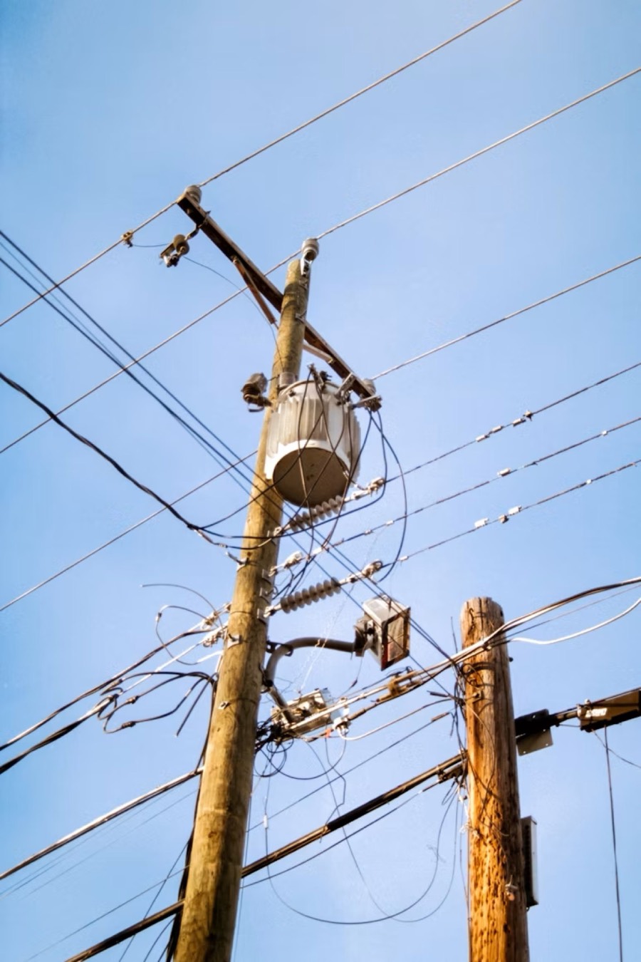 Utility distribution lines and a pole-mounted transformer
